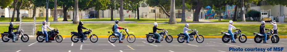 Photo of motorcycle riders lined up in front of instructor