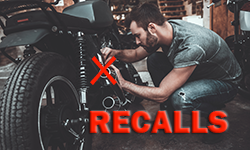 RECALLS -Young bearded man fixing motorcycle 